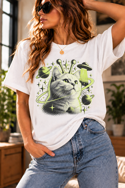 Cosmic cat graphic T-shirt featuring a cat portrait, lime-green planets, rings, stars, and UFOs
