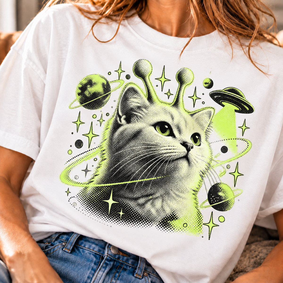 Cosmic cat T-shirt design with planets, stars, and flying saucers